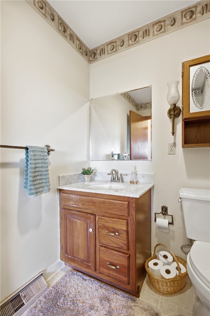 6718 Old Columbus Road South Vienna, OH 45369 - Photo 24 of 33 This bright bathroom features a classic vanity, a functional mirror, and essential fixtures for daily routines.