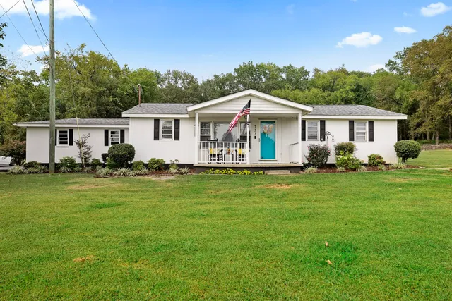 a front view of house with yard and green space