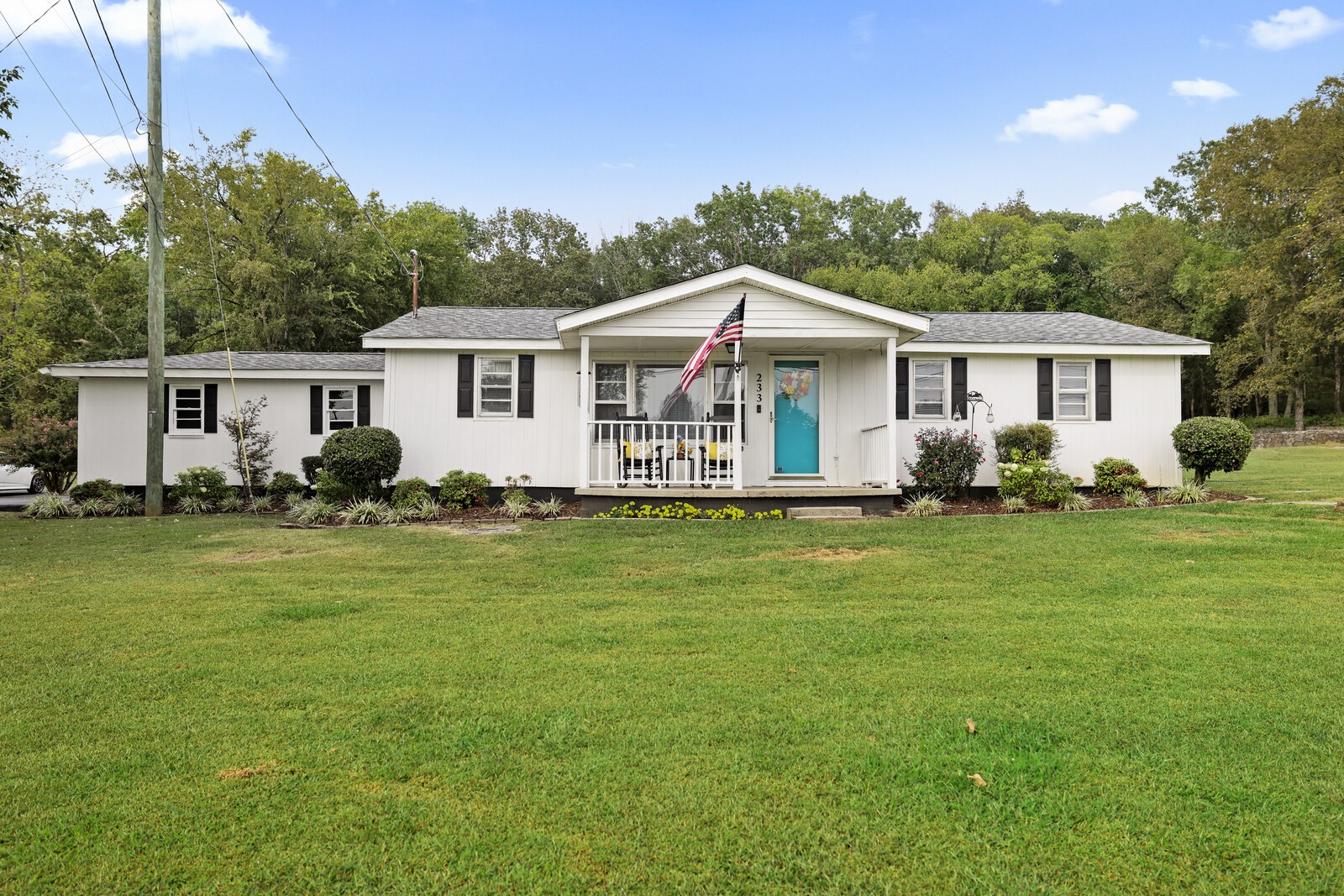 a front view of house with yard and green space
