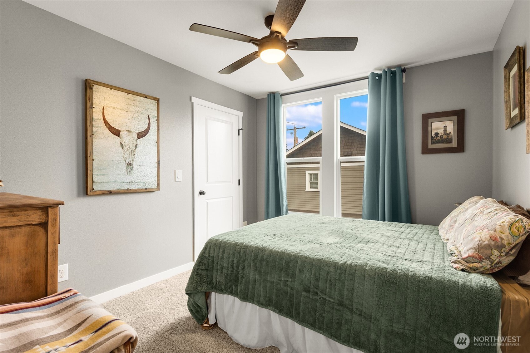 1002 Thompson Street Sumner, WA 98390 - Photo 13 of 38 a bedroom with a large bed and a chandelier fan