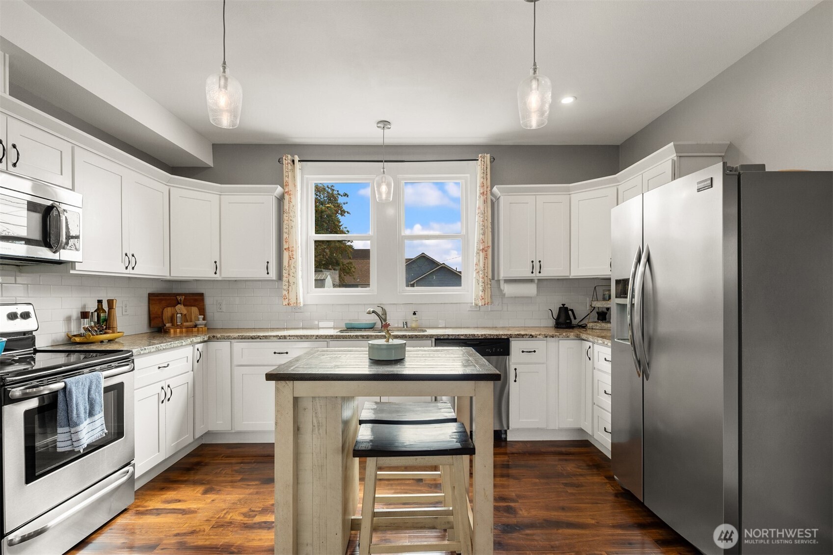 1002 Thompson Street Sumner, WA 98390 - Photo 14 of 38 a kitchen with a sink stove and refrigerator