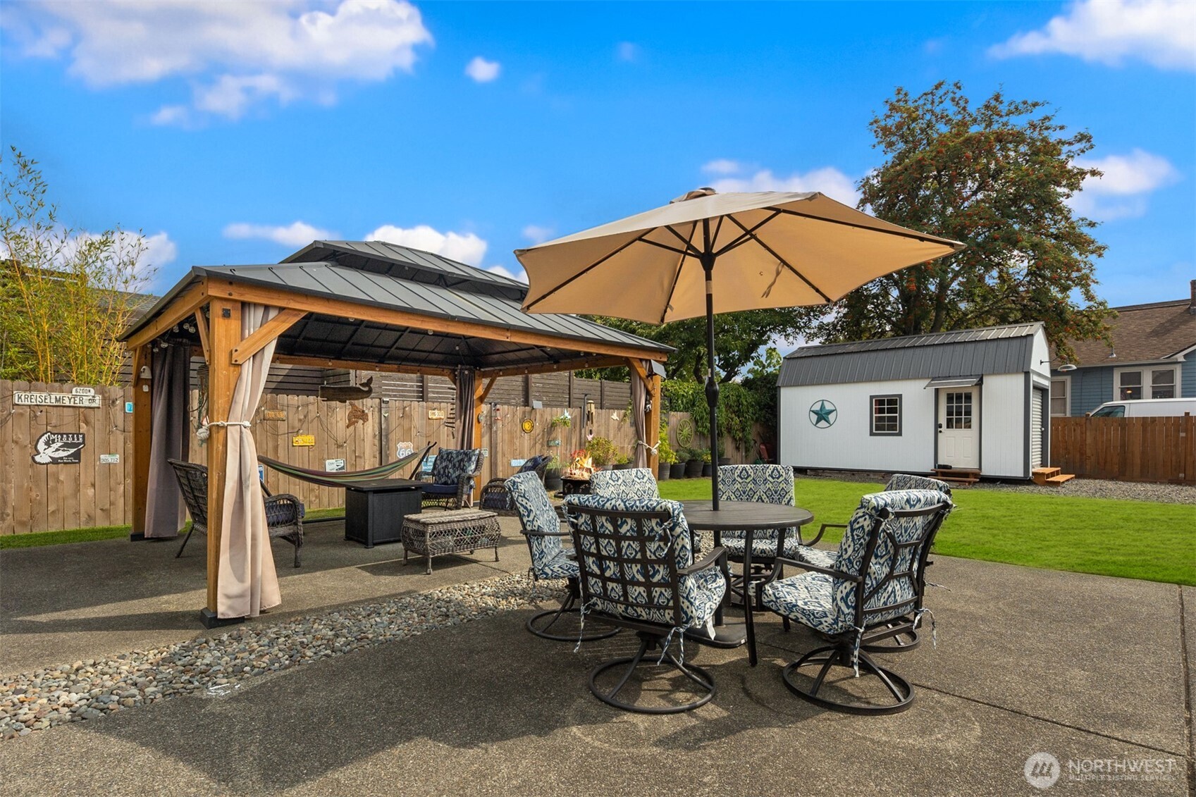 1002 Thompson Street Sumner, WA 98390 - Photo 23 of 38 a view of a patio with table and chairs under an umbrella