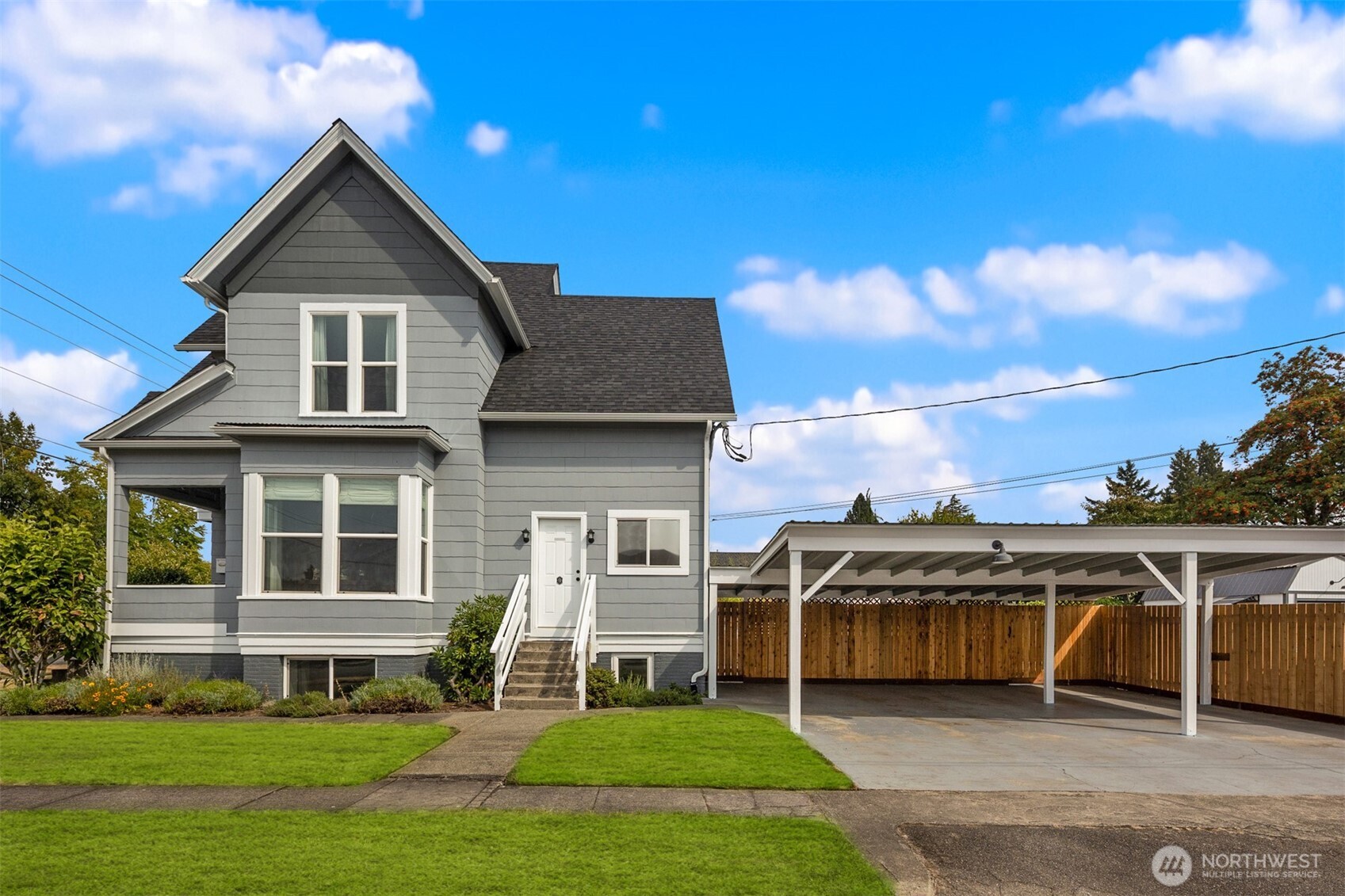 1002 Thompson Street Sumner, WA 98390 - Photo 26 of 38 a front view of a house with a yard