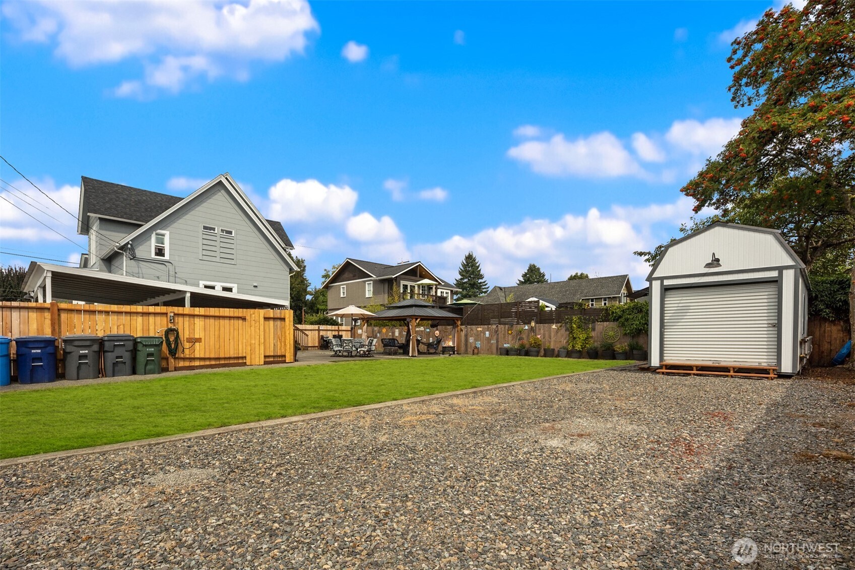 1002 Thompson Street Sumner, WA 98390 - Photo 31 of 38 a view of a big house with a big yard and large trees