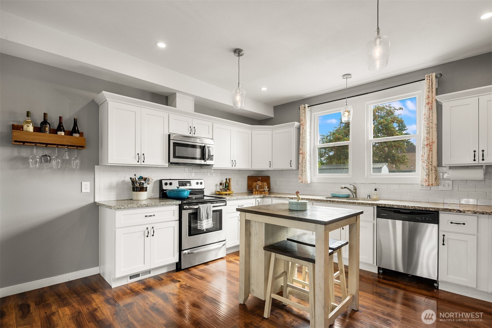 1002 Thompson Street Sumner, WA 98390 - Photo 5 of 38 a kitchen with stainless steel appliances granite countertop a sink and stove top oven