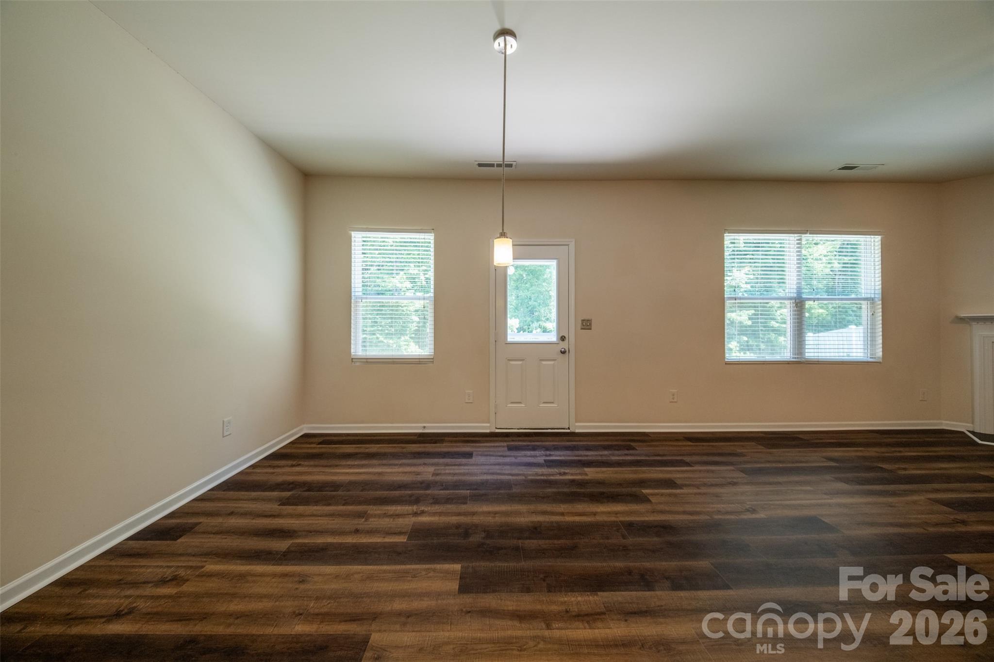 3006 Houndscroft Road Indian Trail, NC 28079 - Photo 18 of 39 a view of an empty room with window and wooden floor