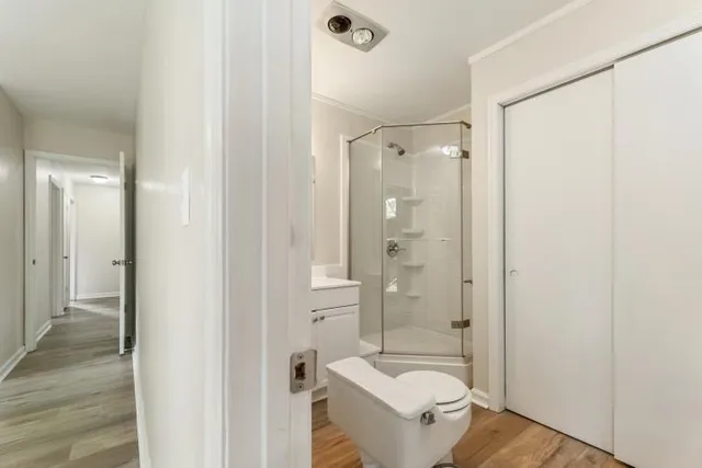 a bathroom with a shower sink and mirror