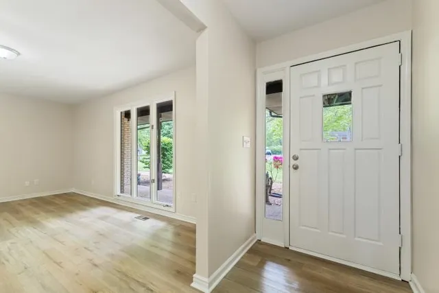 a bedroom with a large bed and a potted plant
