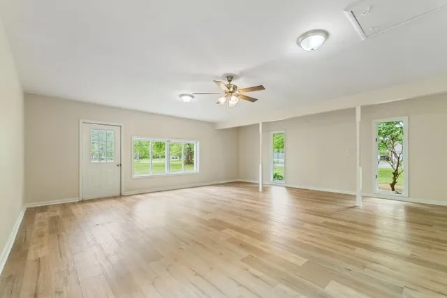 wooden floor in an empty room with a window