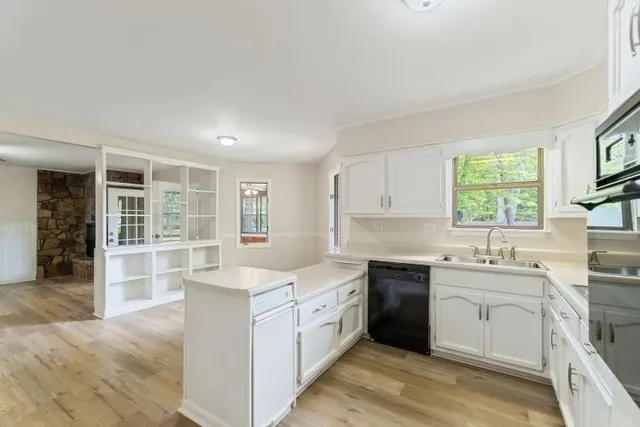 a kitchen with a sink stove and cabinets