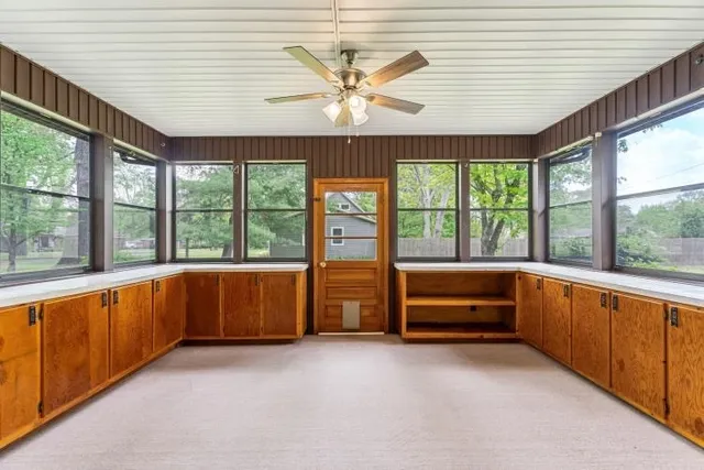 a large white kitchen with a large window