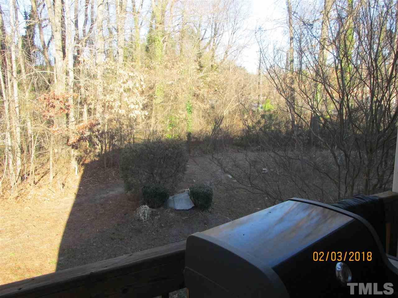 4640 Altha Street Raleigh, NC 27606 - Photo 22 of 25 a blue bench sitting in front of a building