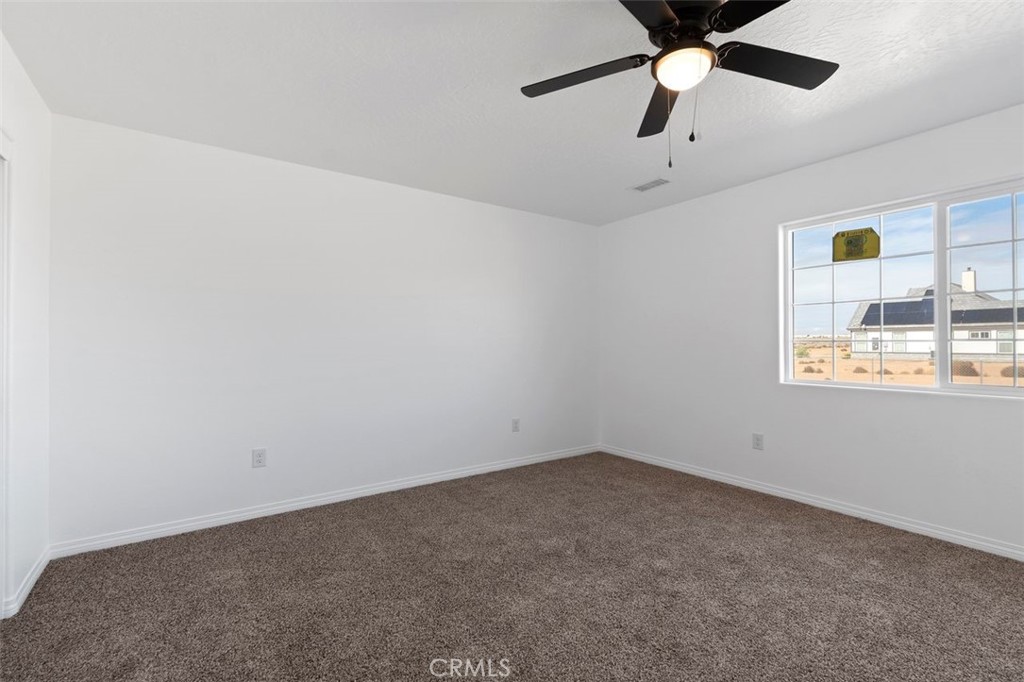 16925 Nanticoke Road Apple Valley, CA 92307 - Photo 18 of 42 an empty room with windows and fan