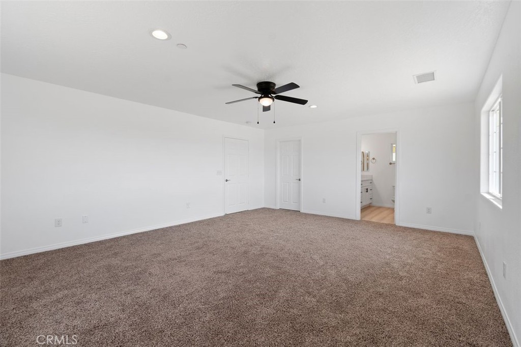 16925 Nanticoke Road Apple Valley, CA 92307 - Photo 28 of 42 an empty room with a ceiling fan and a window