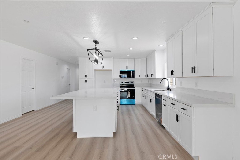 16925 Nanticoke Road Apple Valley, CA 92307 - Photo 34 of 42 a kitchen with white cabinets and white appliances