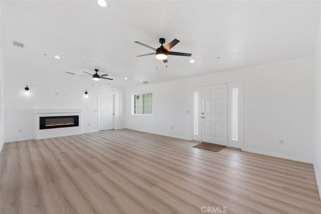 16925 Nanticoke Road Apple Valley, CA 92307 - Photo 38 of 42 a view of an empty room with a window and wooden floor