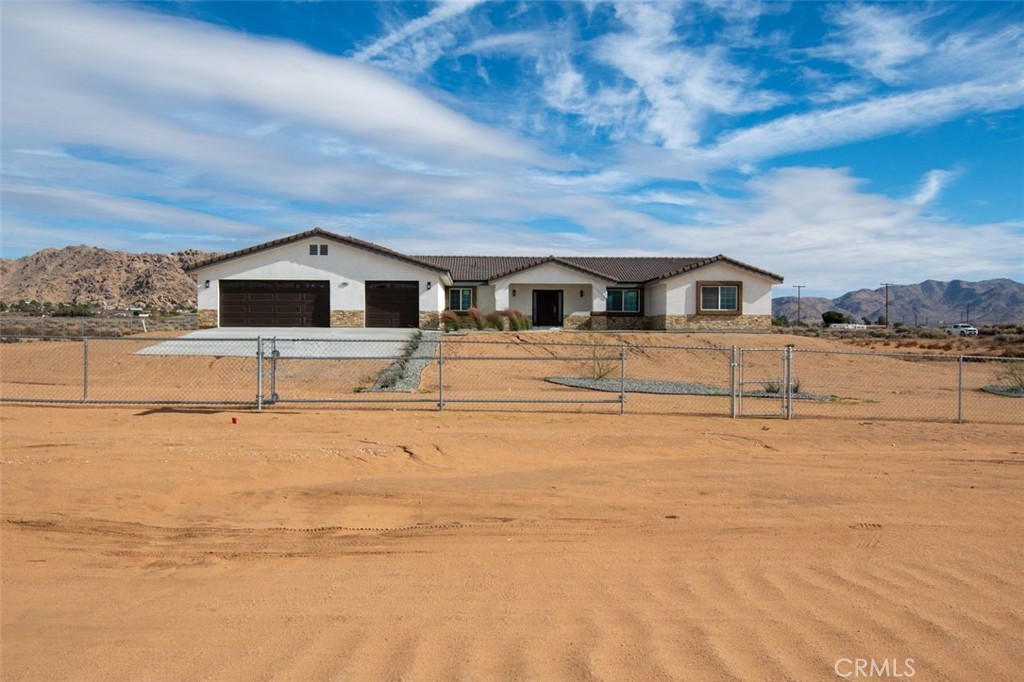 16925 Nanticoke Road Apple Valley, CA 92307 - Photo 9 of 42 a front view of a house with a yard