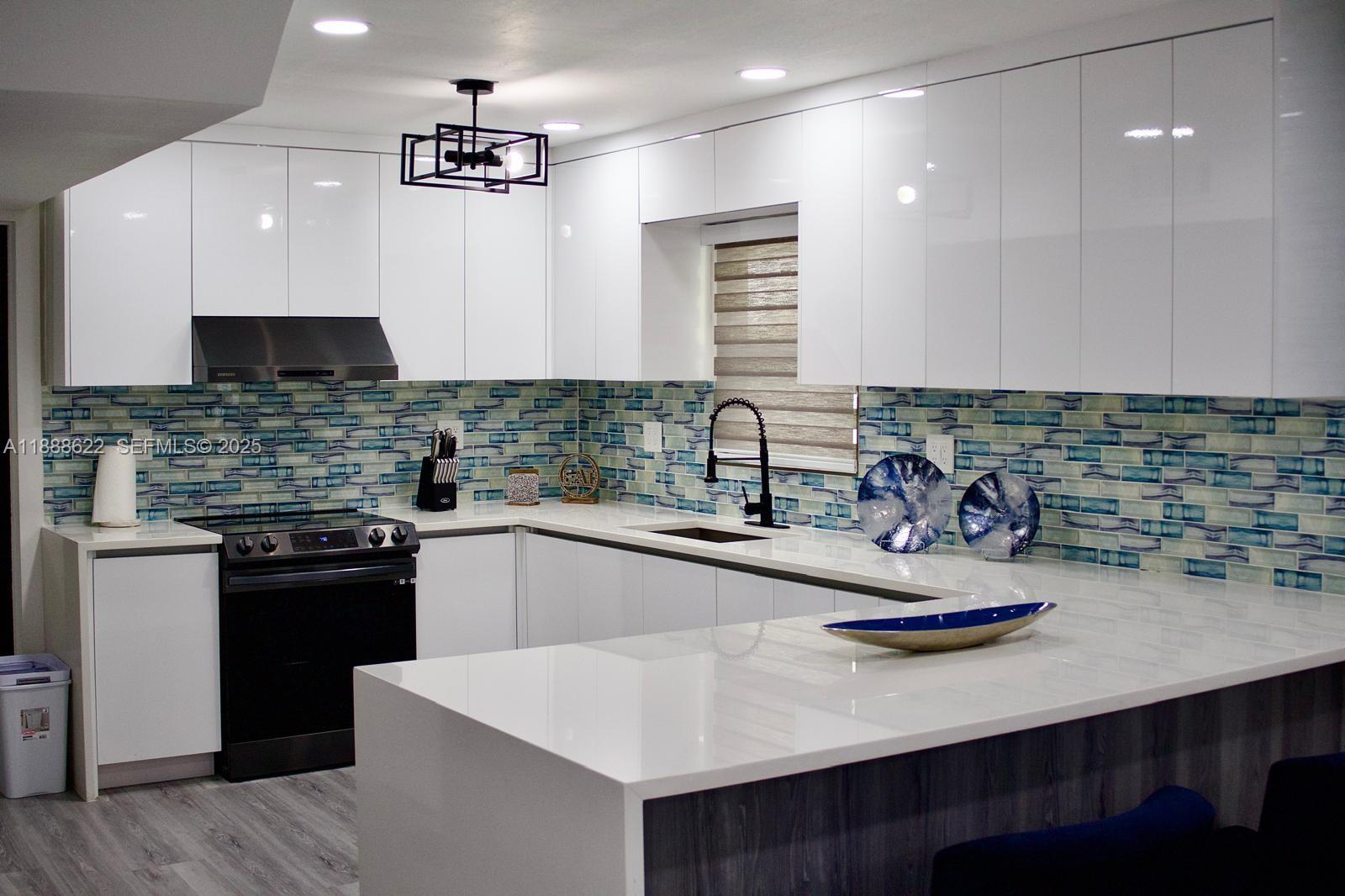 20 Eagle Drive Key Largo, FL 33037 - Photo 18 of 55 a kitchen with sink a stove and chairs