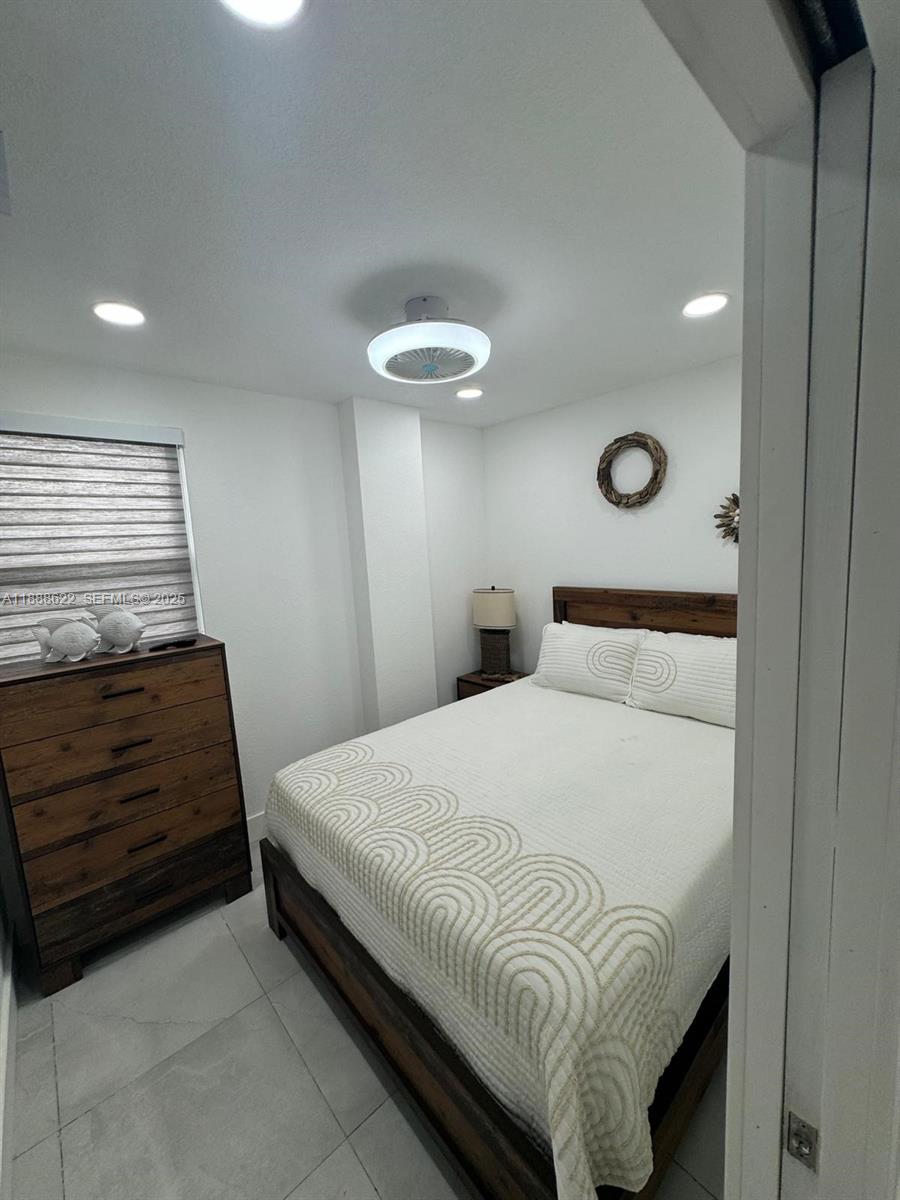 20 Eagle Drive Key Largo, FL 33037 - Photo 25 of 55 a bedroom with a bed and a ceiling fan