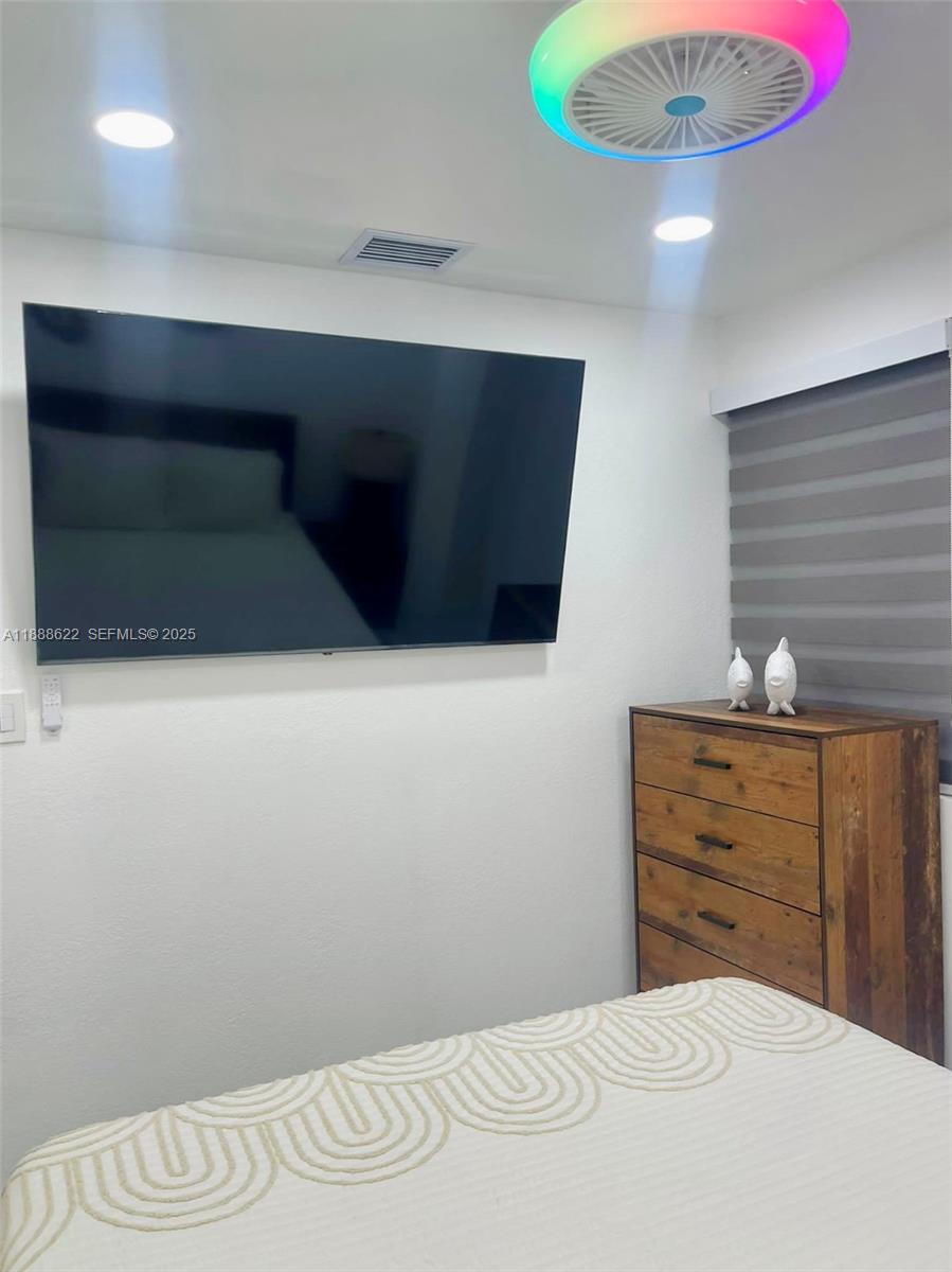 20 Eagle Drive Key Largo, FL 33037 - Photo 27 of 55 a bedroom with a bed and a chandelier