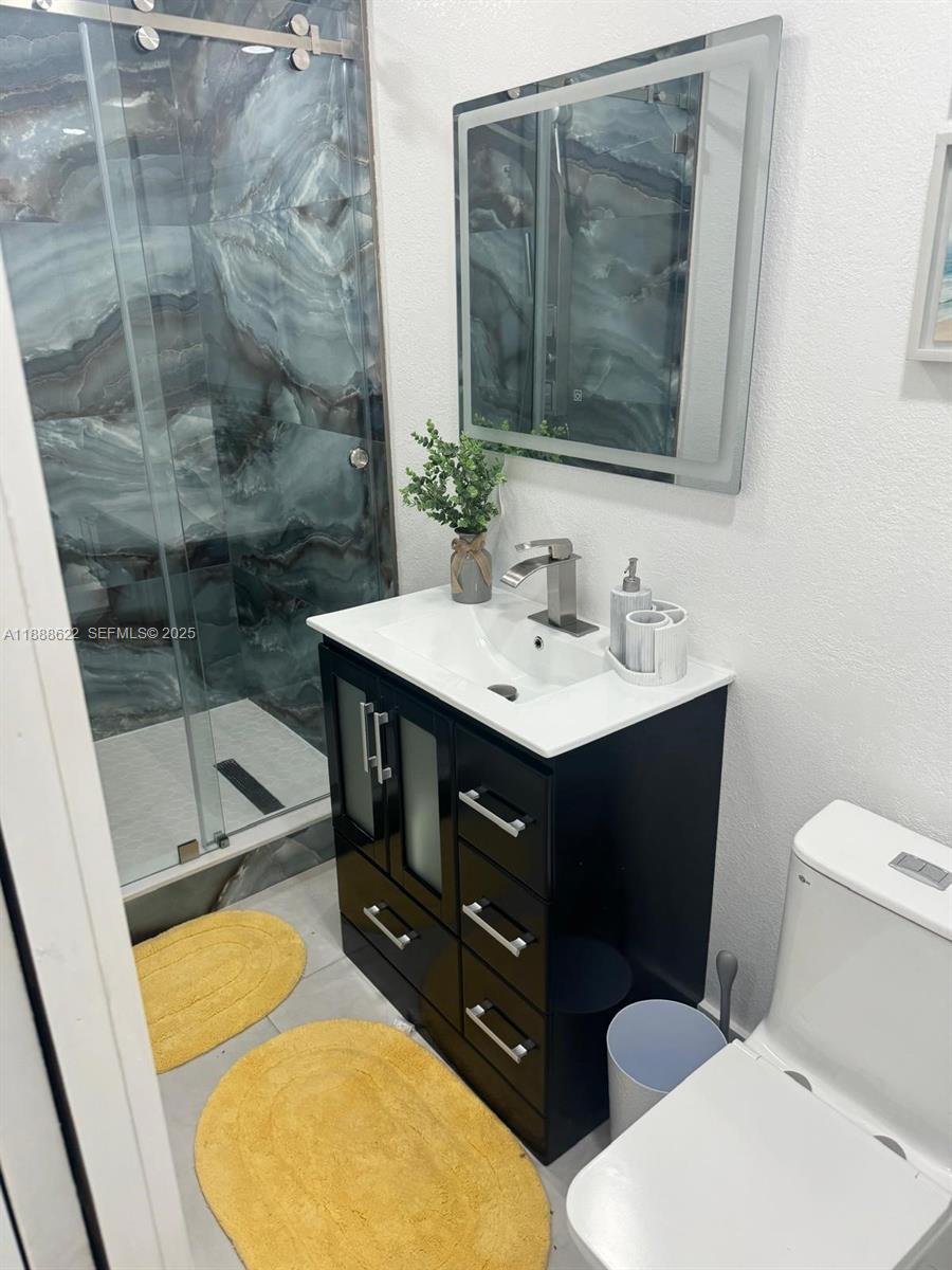 20 Eagle Drive Key Largo, FL 33037 - Photo 32 of 55 a bathroom with a sink mirror vanity and toilet