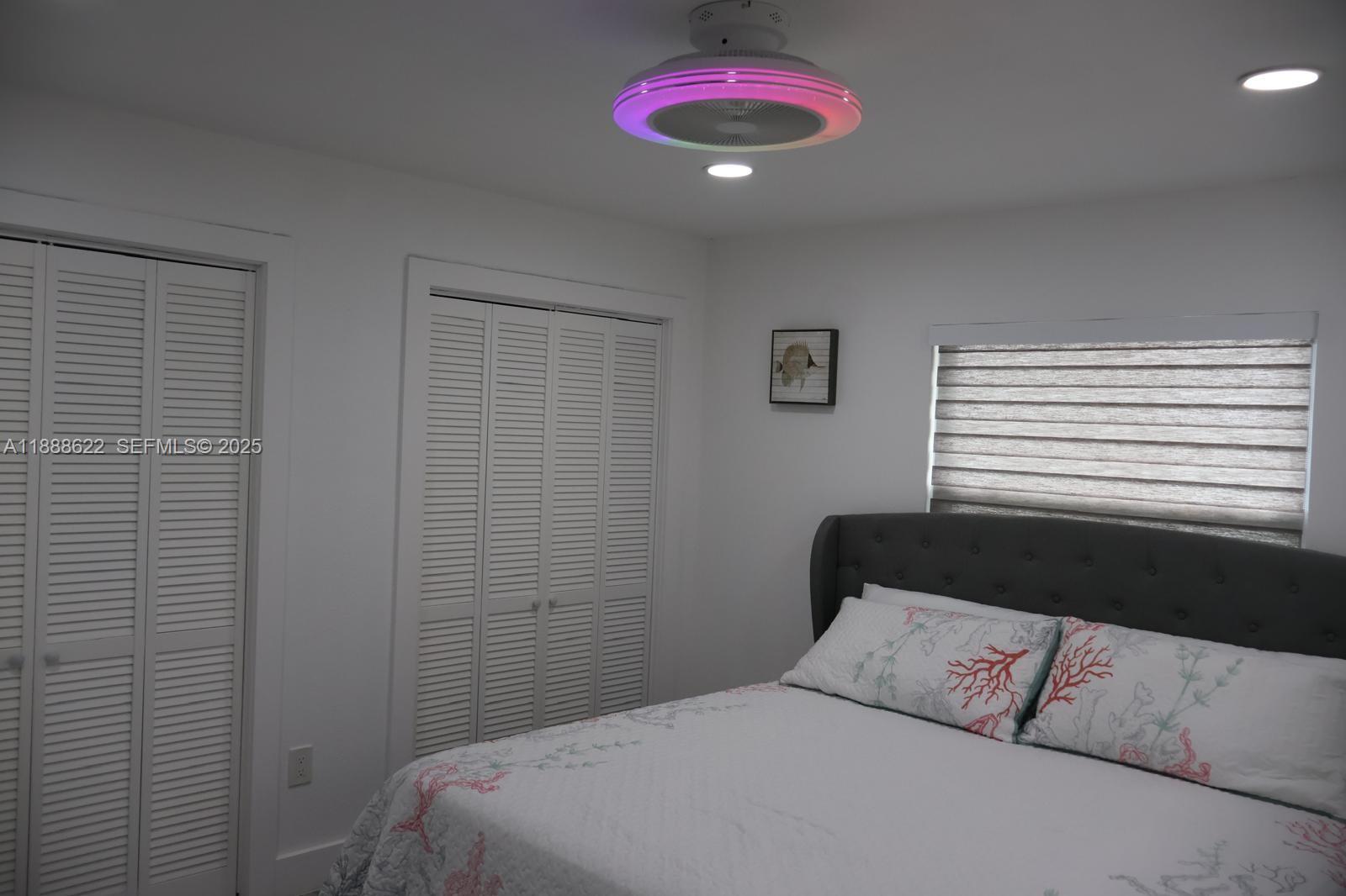 20 Eagle Drive Key Largo, FL 33037 - Photo 35 of 55 a bedroom with a bed and a chandelier