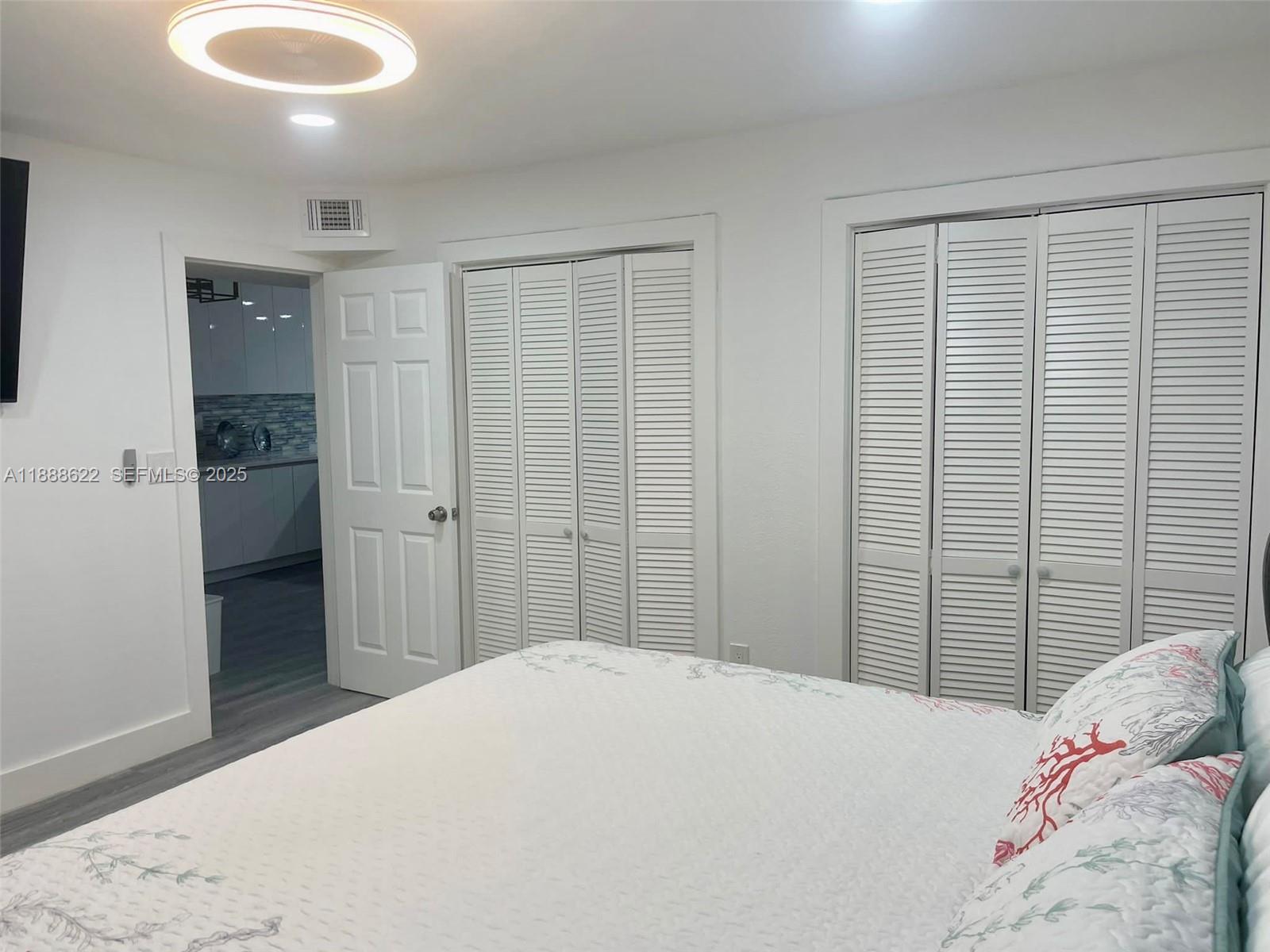 20 Eagle Drive Key Largo, FL 33037 - Photo 36 of 55 a bedroom with a bed and a chandelier