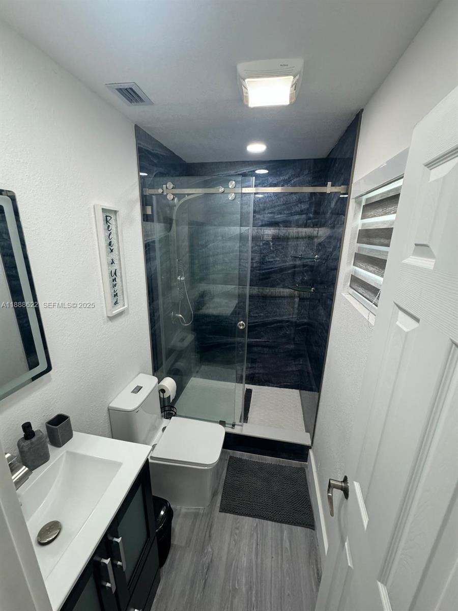 20 Eagle Drive Key Largo, FL 33037 - Photo 44 of 55 a bathroom with a sink a toilet a mirror and shower