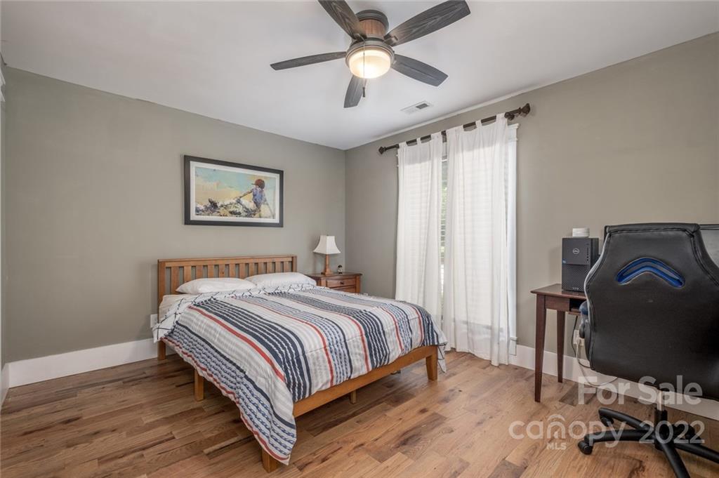 5932 Deal Road Matthews, NC 28104 - Photo 20 of 41 a bedroom with a bed and a chandelier