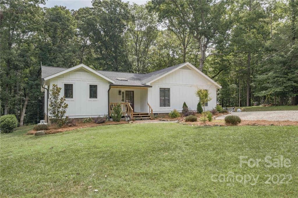 5932 Deal Road Matthews, NC 28104 - Photo 2 of 41 a front view of a house with a garden and trees