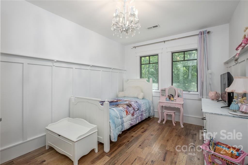 5932 Deal Road Matthews, NC 28104 - Photo 22 of 41 a bedroom with a bed and a chandelier
