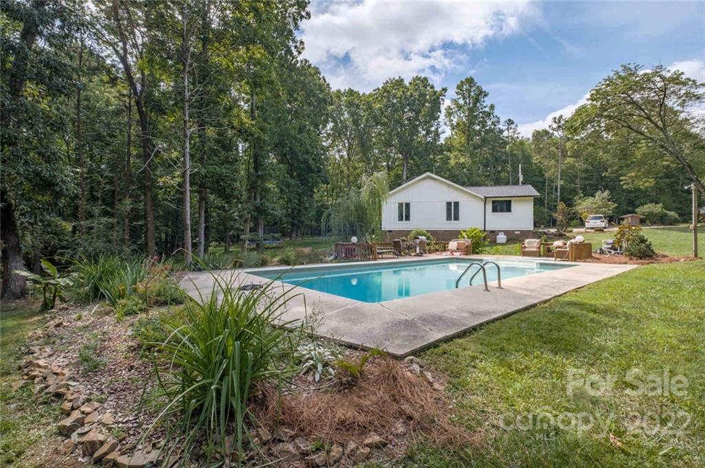 5932 Deal Road Matthews, NC 28104 - Photo 27 of 41 a view of a house with swimming pool and a yard