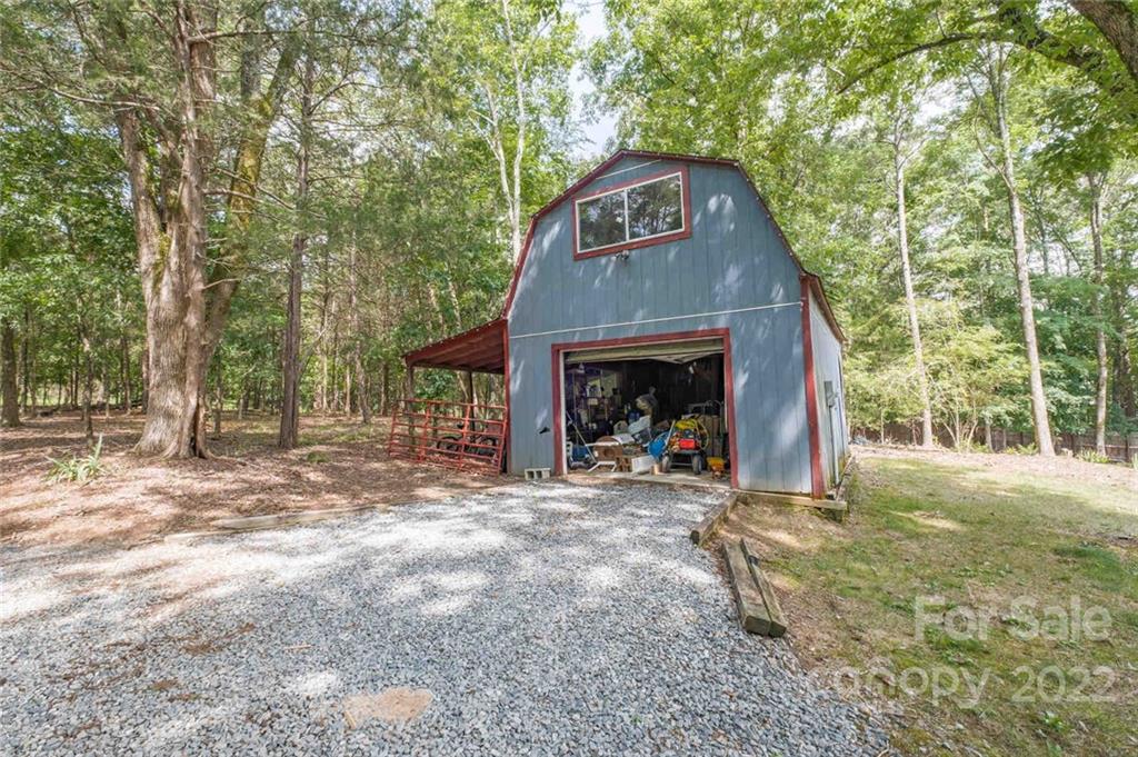 5932 Deal Road Matthews, NC 28104 - Photo 33 of 41 a view of a wooden house with a small yard and large tree