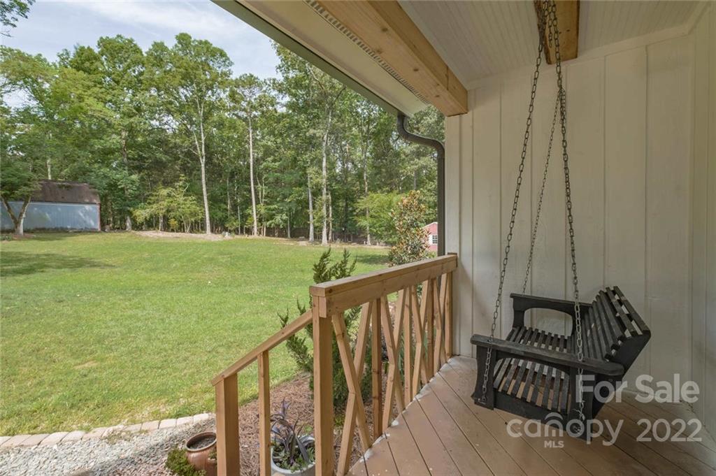 5932 Deal Road Matthews, NC 28104 - Photo 4 of 41 a view of a balcony with chairs and wooden floor