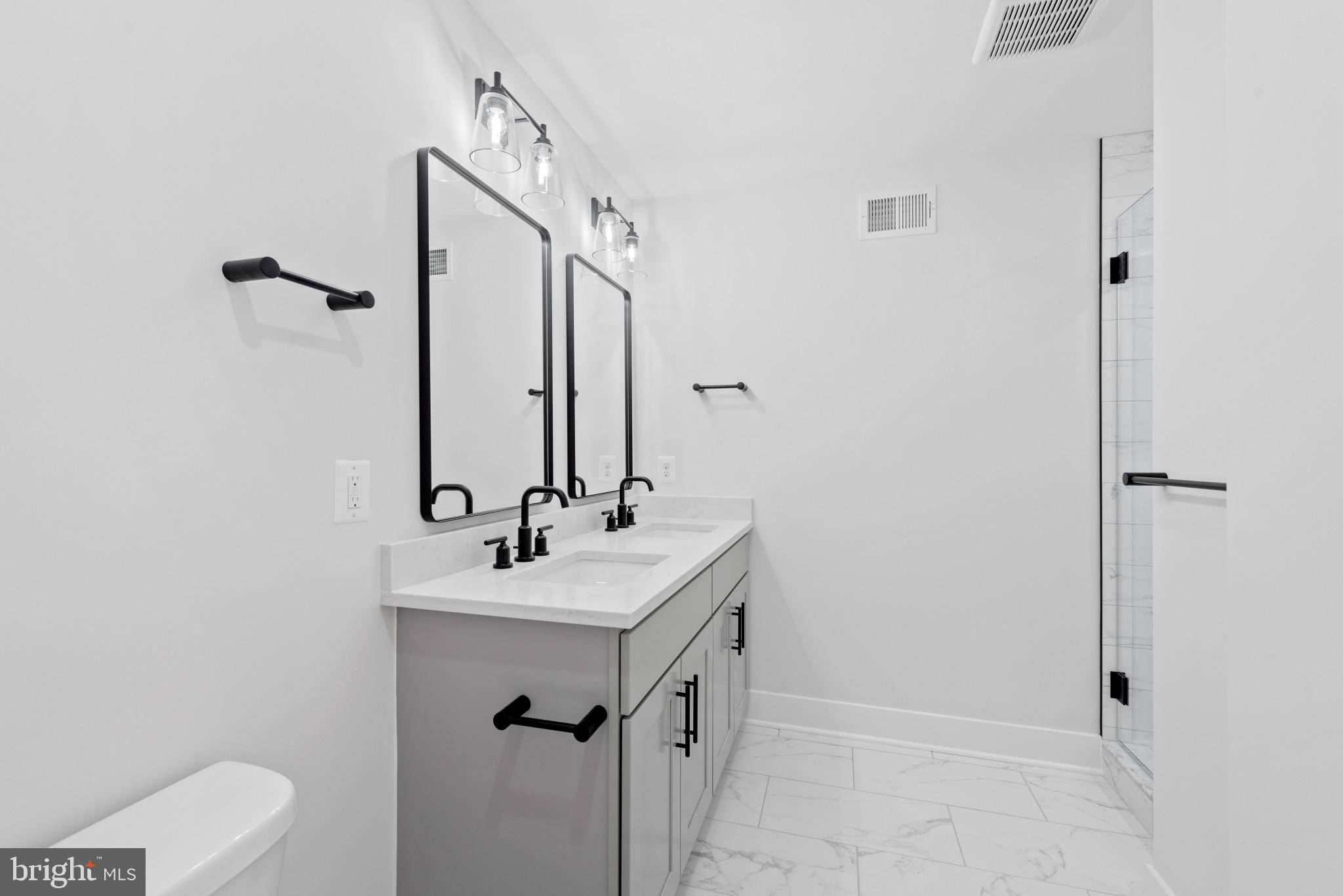 1434 Marshall Street Baltimore, MD 21230 - Photo 29 of 40 a bathroom with a sink a toilet and shower