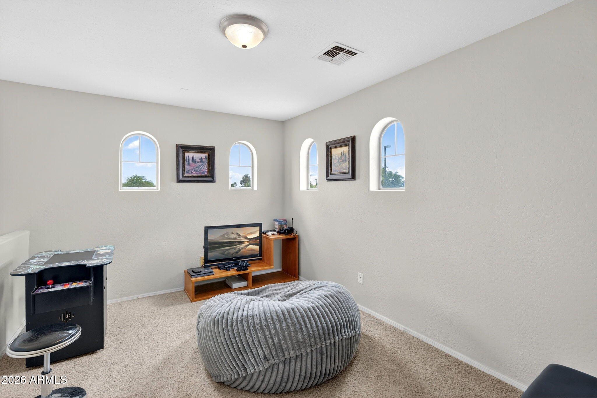 6280 South Sinova Court Gilbert, AZ 85298 - Photo 29 of 64 a bedroom with a bed and a lamp on the wall