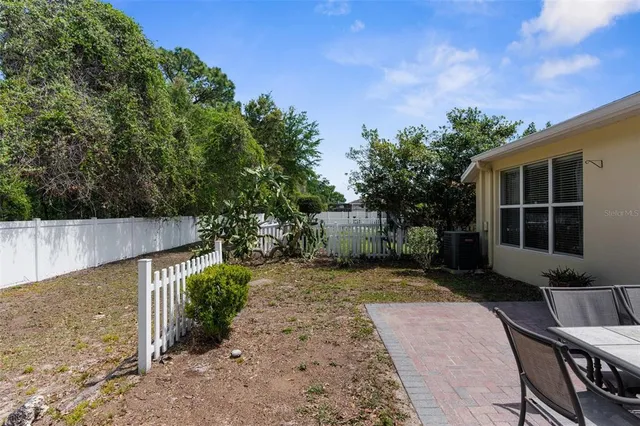 a view of a backyard with plants and a patio