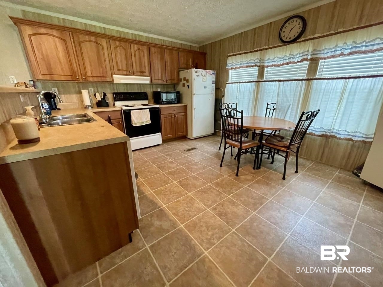 15338 Windbigler Drive Foley, AL 36535 - Photo 15 of 28 Kitchen with white appliances, a healthy amount of sunlight, sink, and a textured ceiling