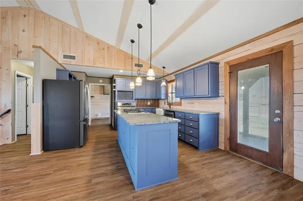 a kitchen with granite countertop stainless steel appliances and wooden cabinets