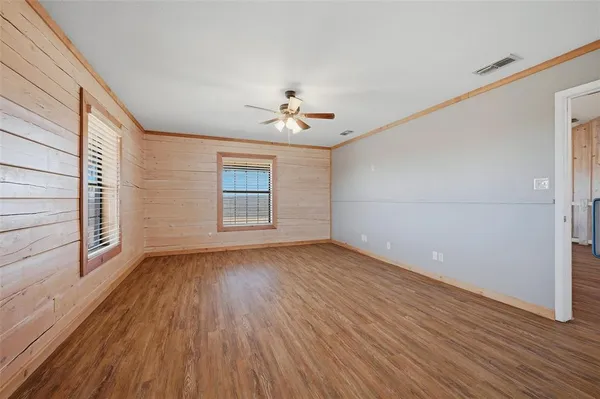 a kitchen with a stove and a wooden floor
