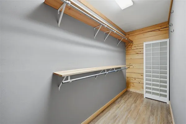 a kitchen with granite countertop white cabinets and wooden floor