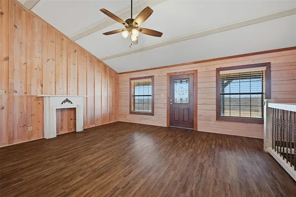 a kitchen with granite countertop a sink a counter space appliances and cabinets