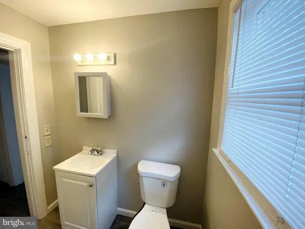 a white toilet sitting next to a bathroom sink