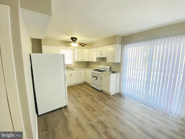 a kitchen with a sink a stove and cabinets