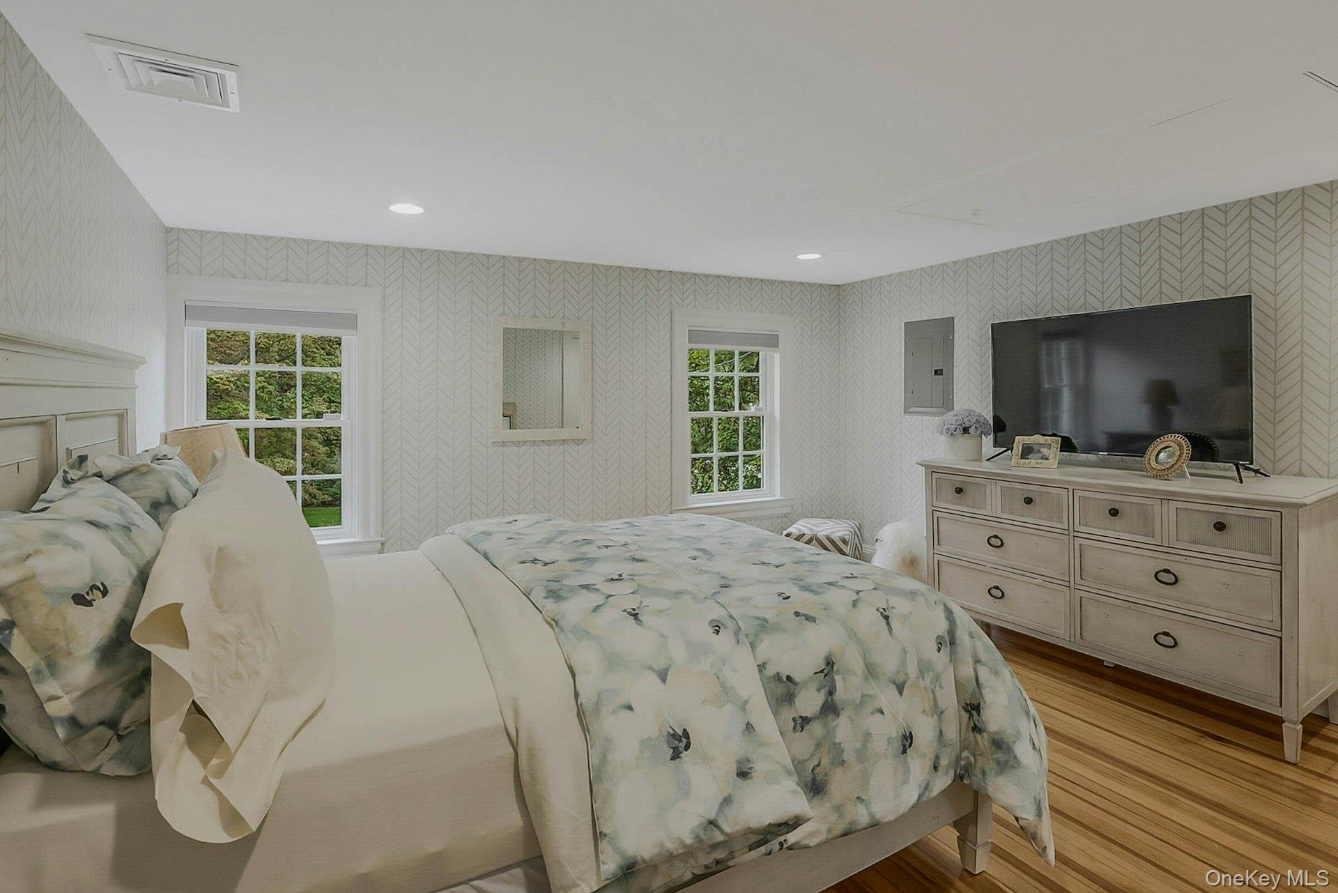 236 Berry Hill Road Syosset, NY 11791 - Photo 16 of 27 Bedroom with wallpapered walls, light wood-style flooring, electric panel, and recessed lighting
