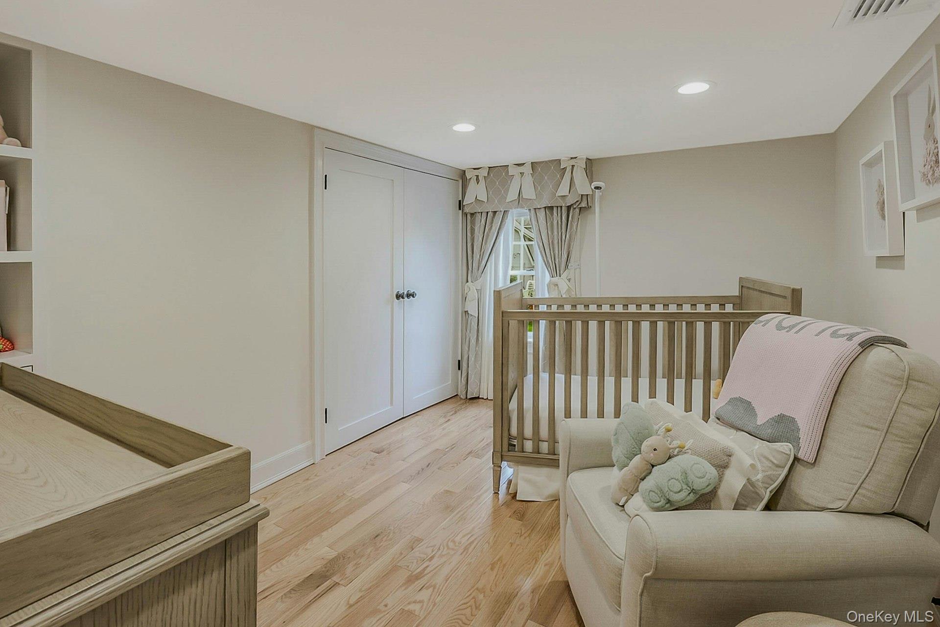 236 Berry Hill Road Syosset, NY 11791 - Photo 22 of 27 Bedroom featuring light wood-style floors, a nursery area, and recessed lighting