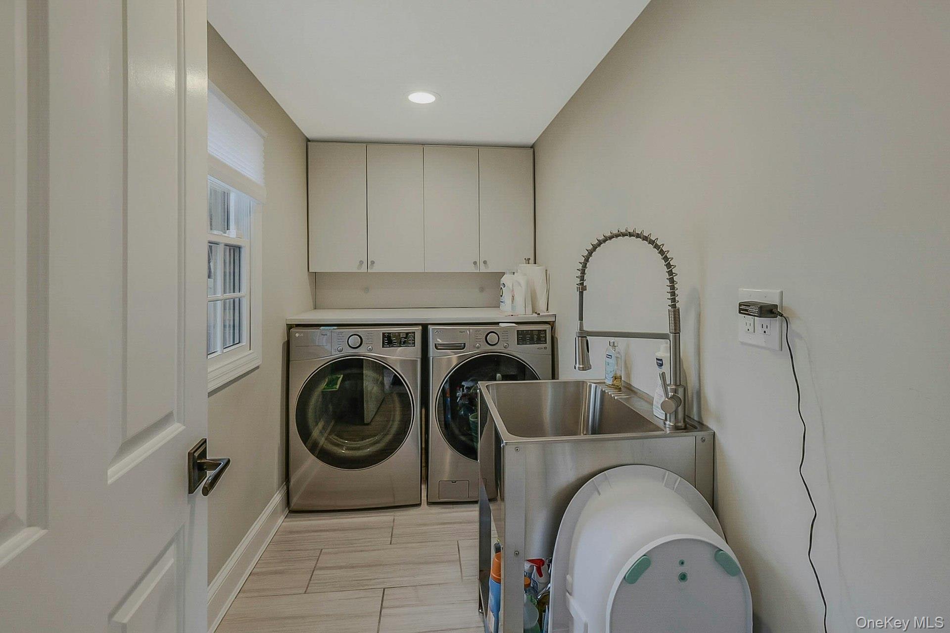 236 Berry Hill Road Syosset, NY 11791 - Photo 23 of 27 Laundry area featuring separate washer and dryer, cabinet space, wood finish floors, and recessed lighting