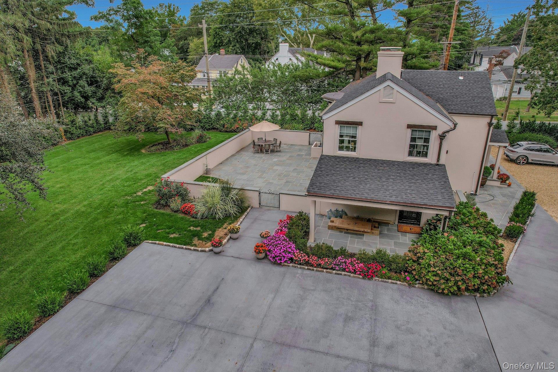 236 Berry Hill Road Syosset, NY 11791 - Photo 3 of 27 View of front of property featuring a shingled roof, stucco siding, a chimney, and a front lawn