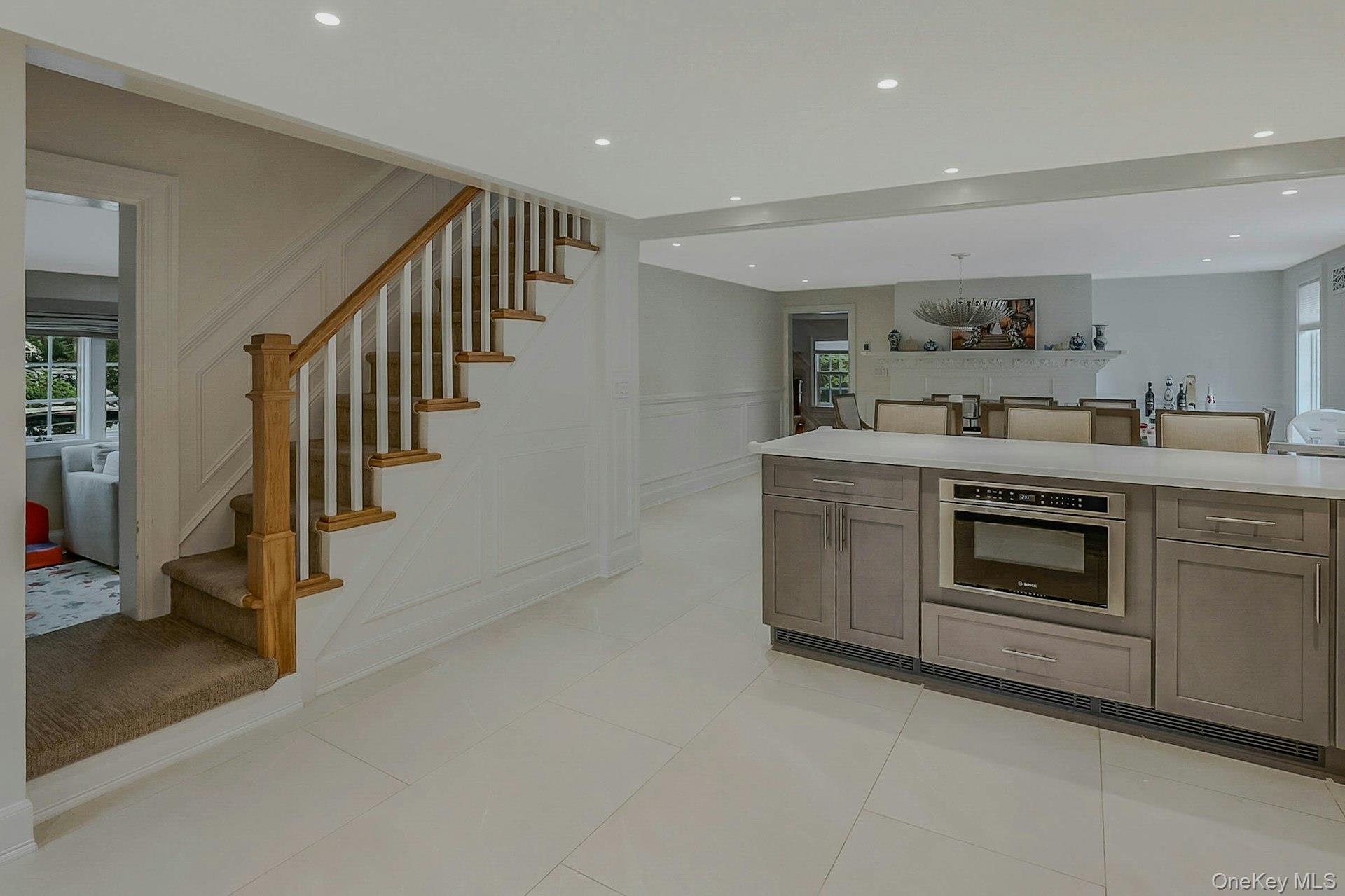 236 Berry Hill Road Syosset, NY 11791 - Photo 6 of 27 Kitchen with a decorative wall, stainless steel oven, recessed lighting, wainscoting, and light tile patterned floors