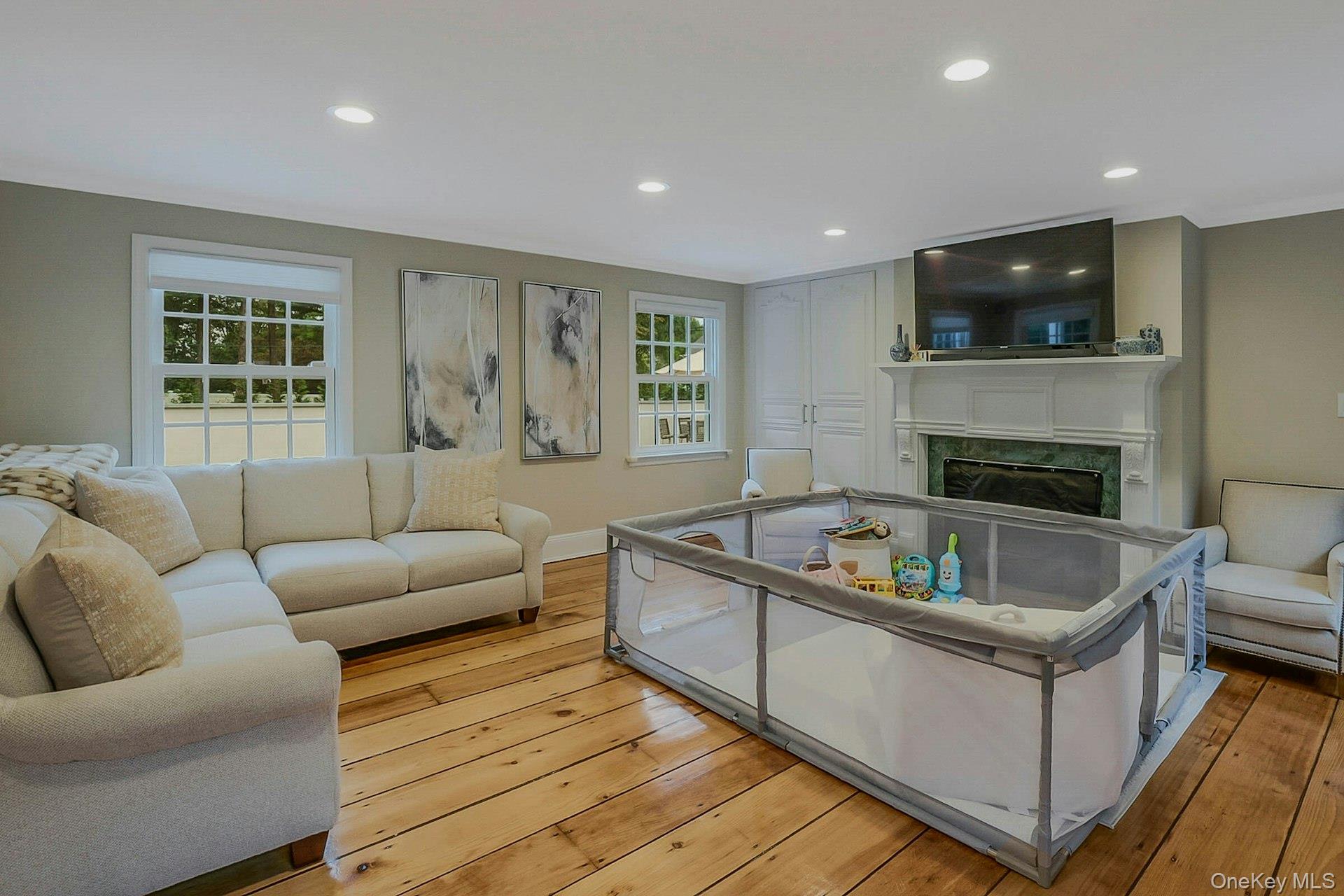 236 Berry Hill Road Syosset, NY 11791 - Photo 10 of 27 Living room with ornamental molding, light wood-style flooring, recessed lighting, and a high end fireplace